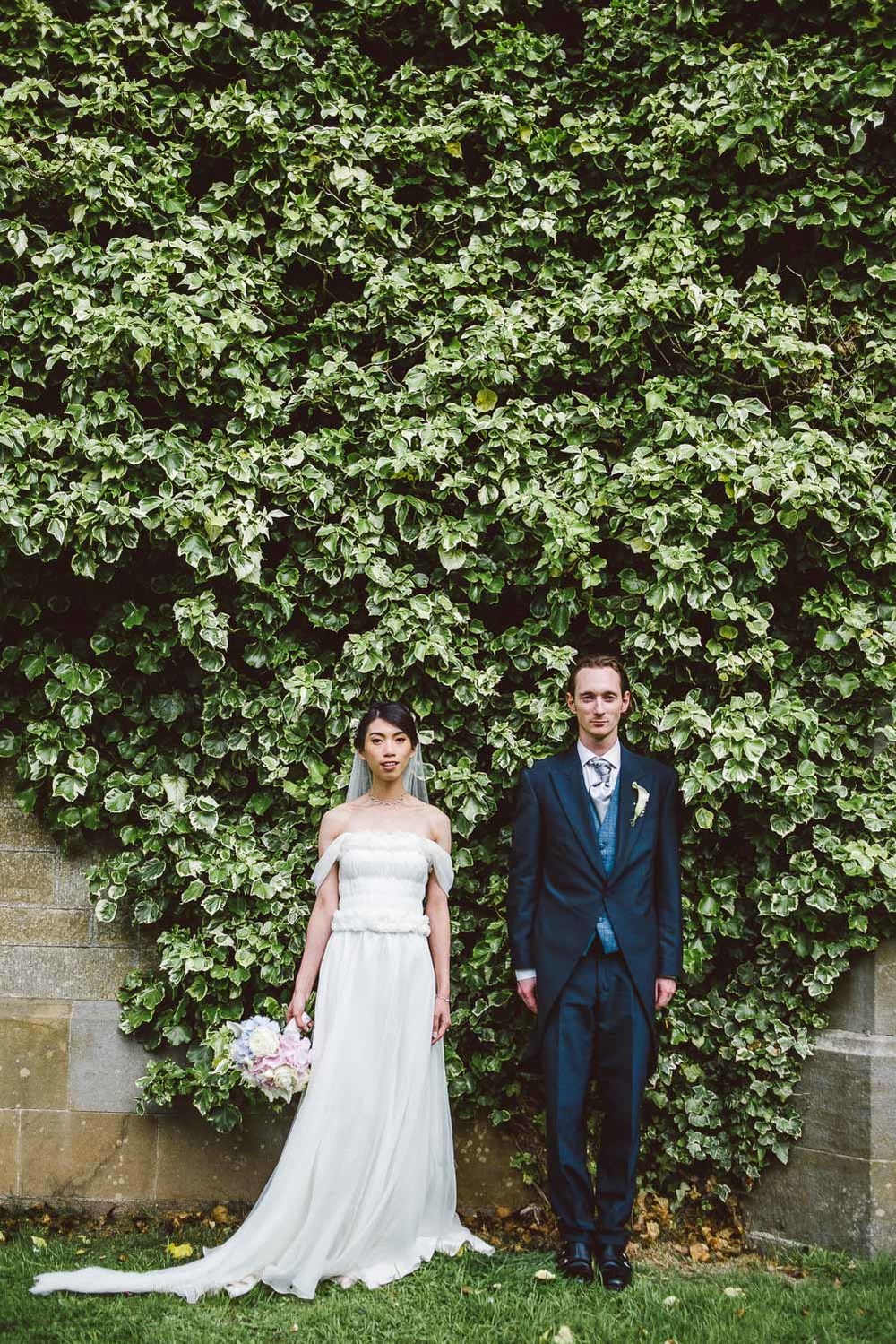 Bride and groom in front of ivy wall. Parkanour Manor House Wedding.