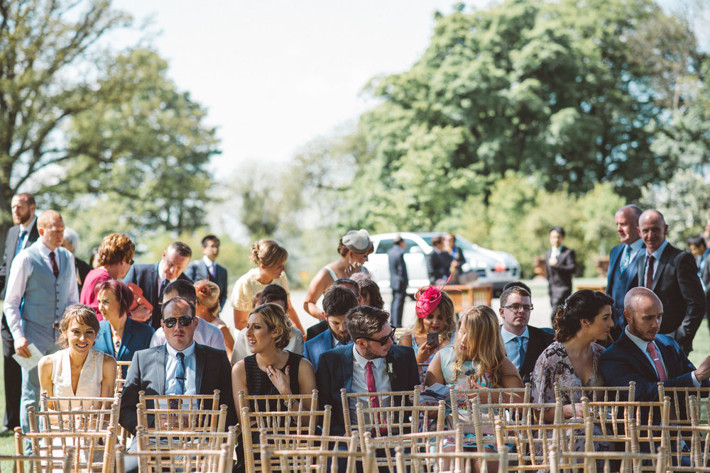 wedding guest sitting at service location outside 