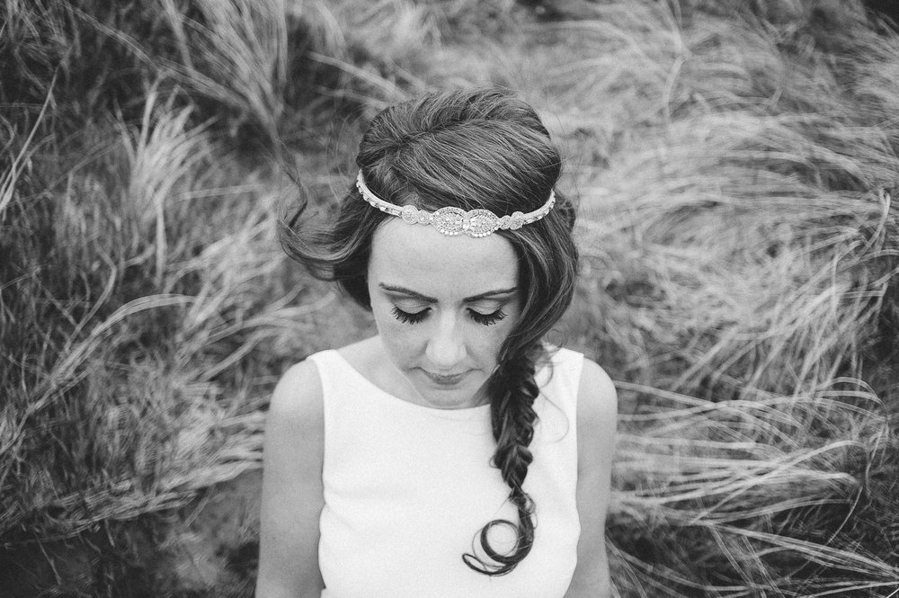 brides hair in loose plat with boho headband