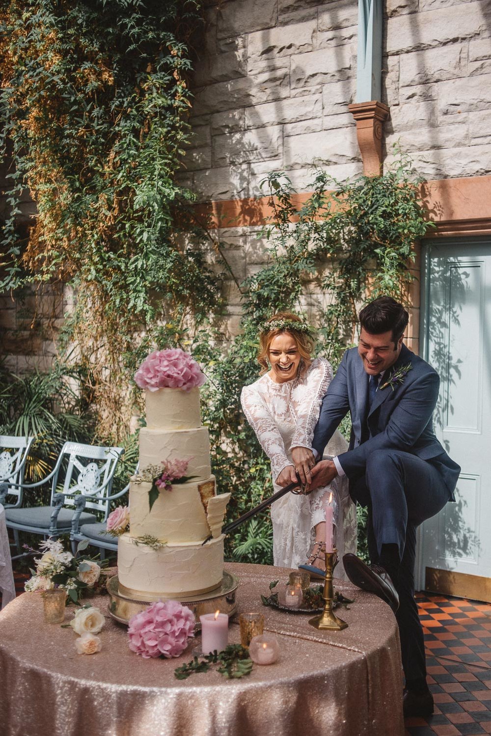 bride and groom cut wedding cake with sword Castle Leslie Wedding.