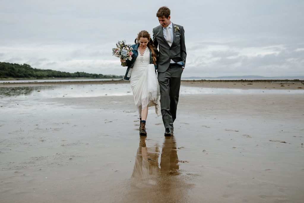 bride and groom walk towards camera 