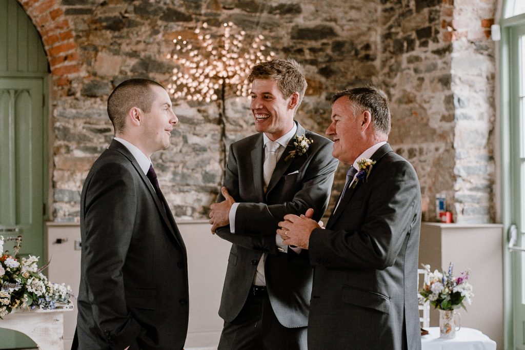 groom taling with groomsmen 