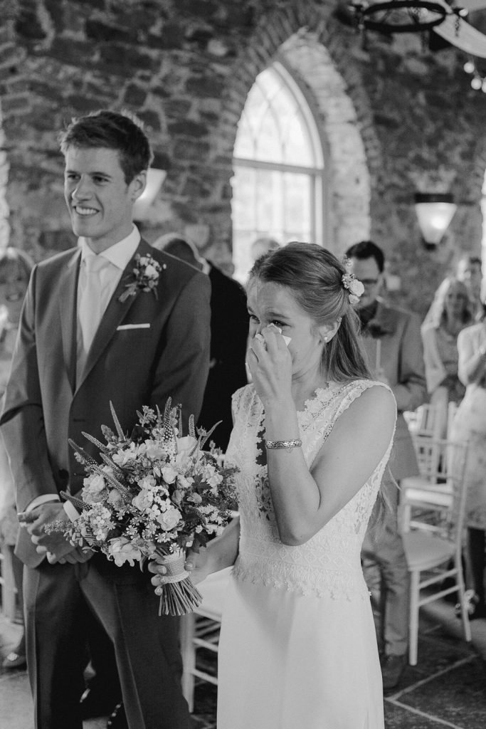 bride wipes tears away 