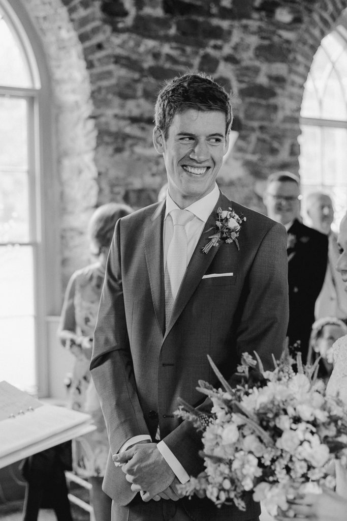 groom smiling to his bride 