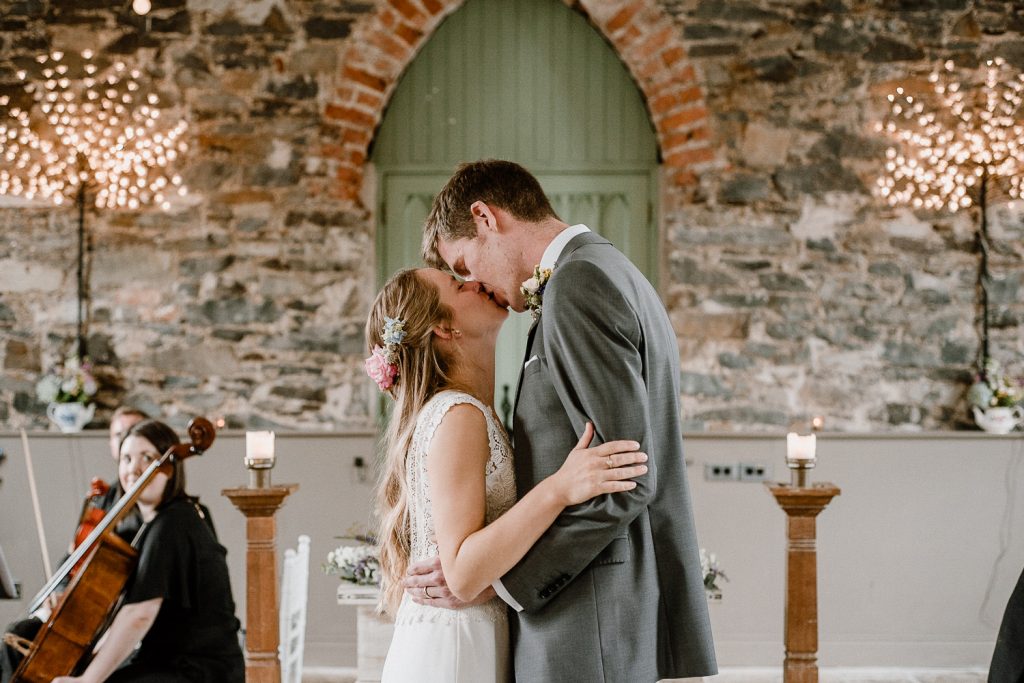bride and groom share first kiss 
