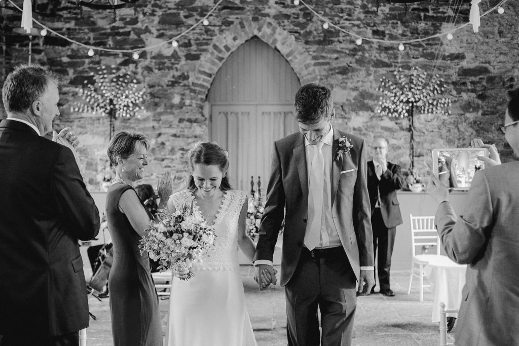 bride and groom walk down the aisle 
