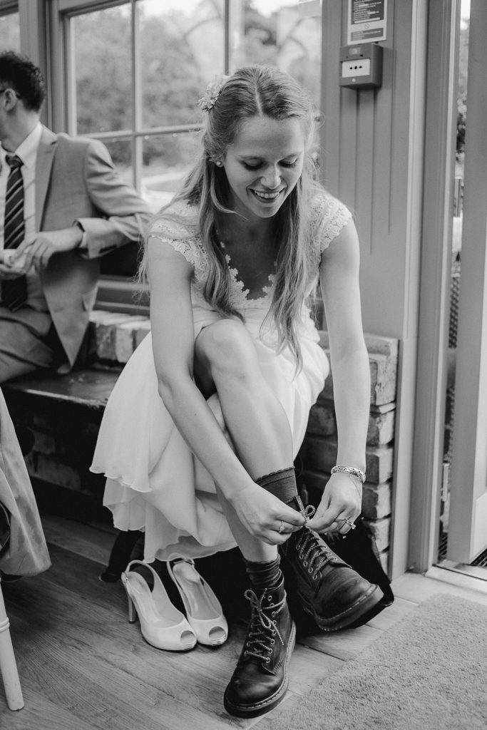 bride laces up her dm boots 