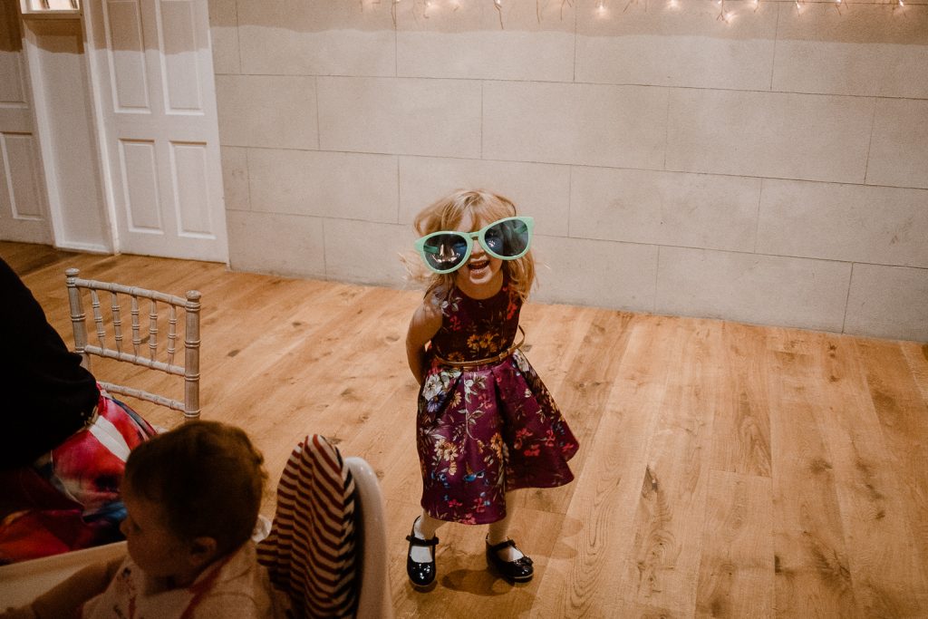 little girl wearing dress and big joke glasses