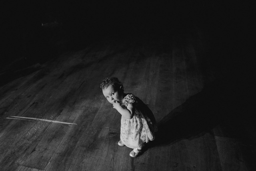 little girl looks at camera