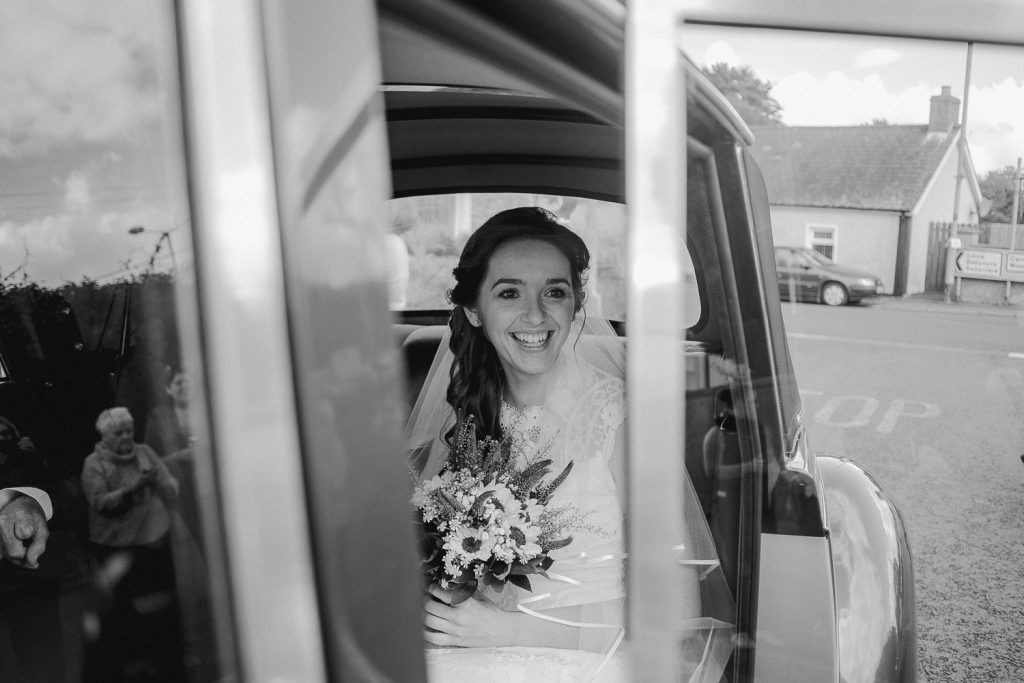 bride in wedding car at church