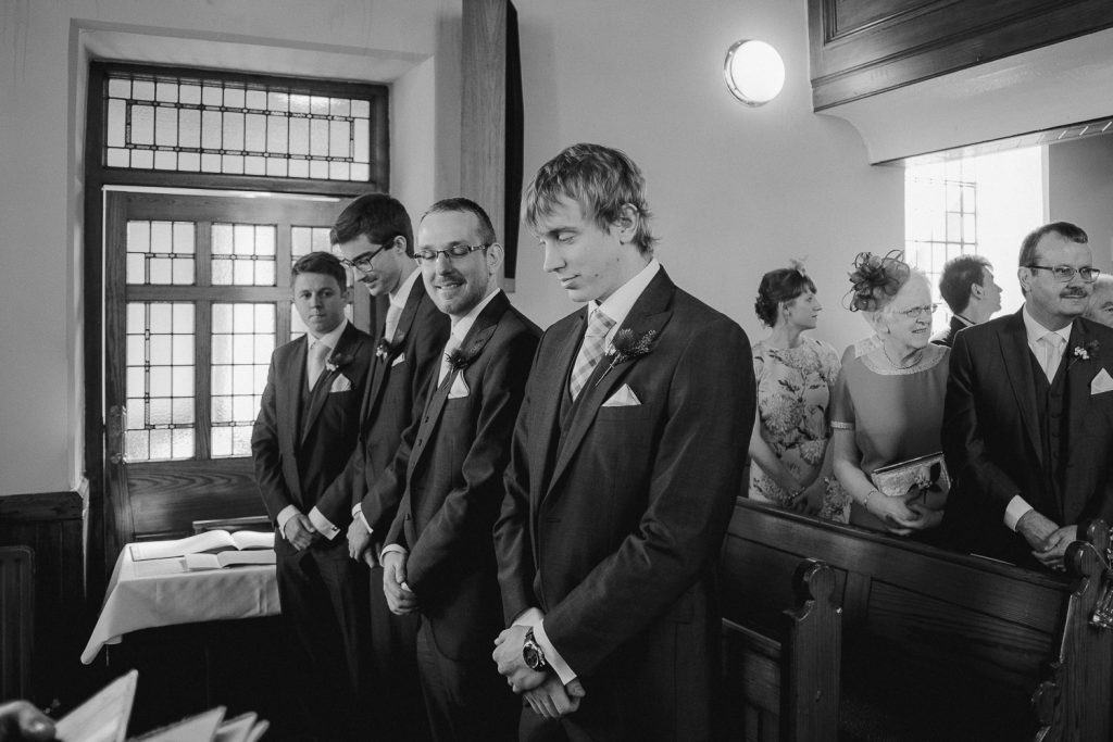 groom waiting at the alter