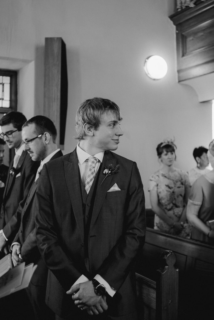groom looking back at bride