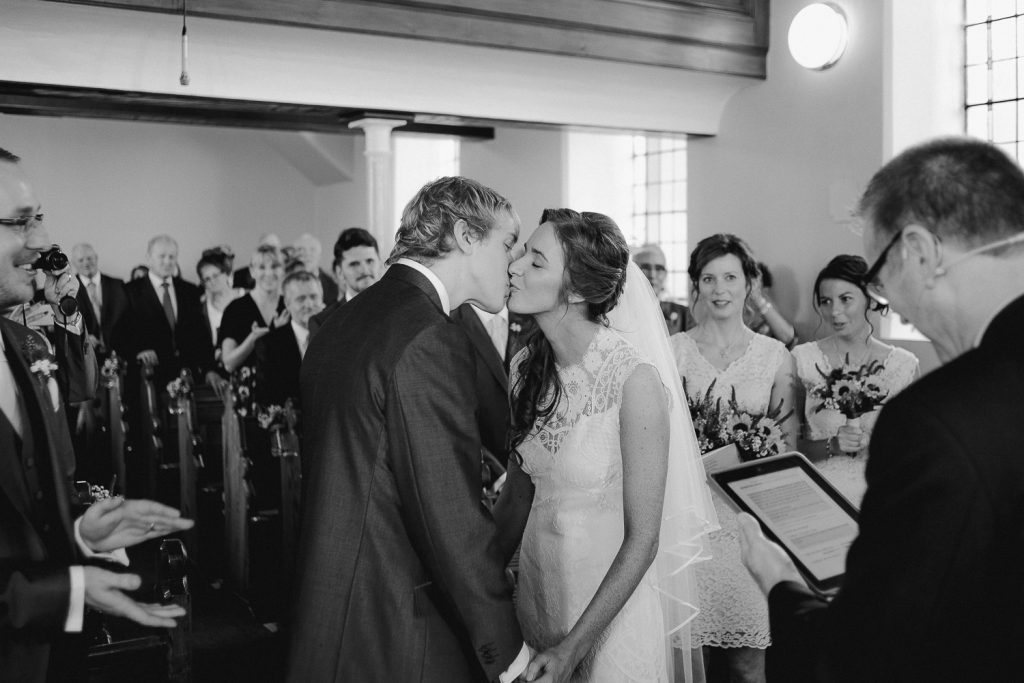 bride and groom first kiss