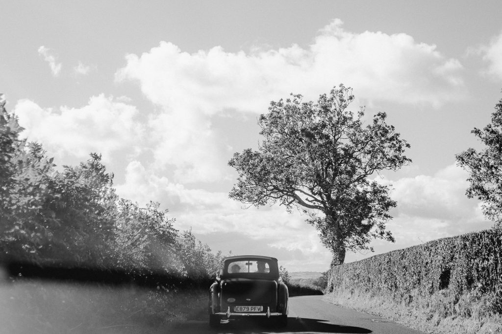 wedding car driving on road