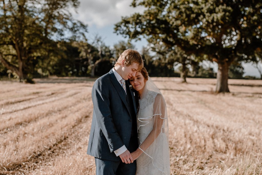 Couple snuggle in together. Gracehall wedding
