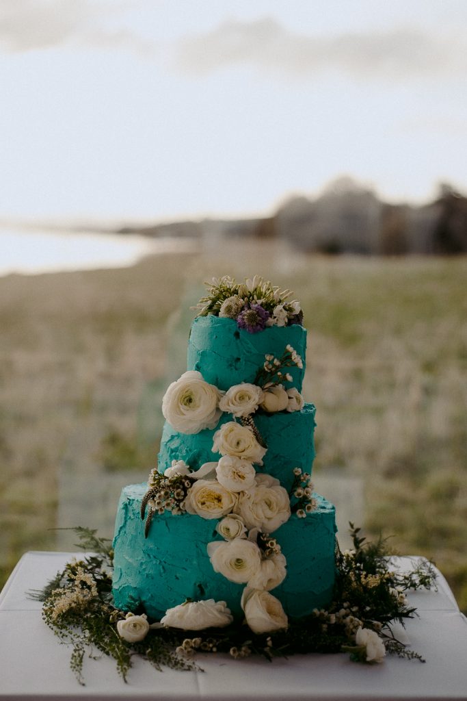 blue wedding cake with white flowers 