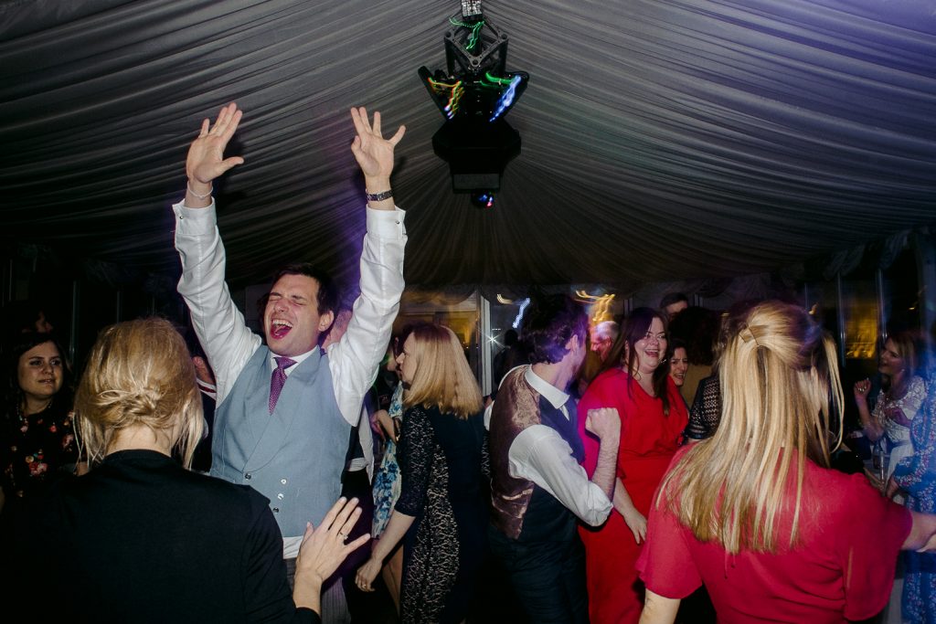wedding guests cheering and dancing 