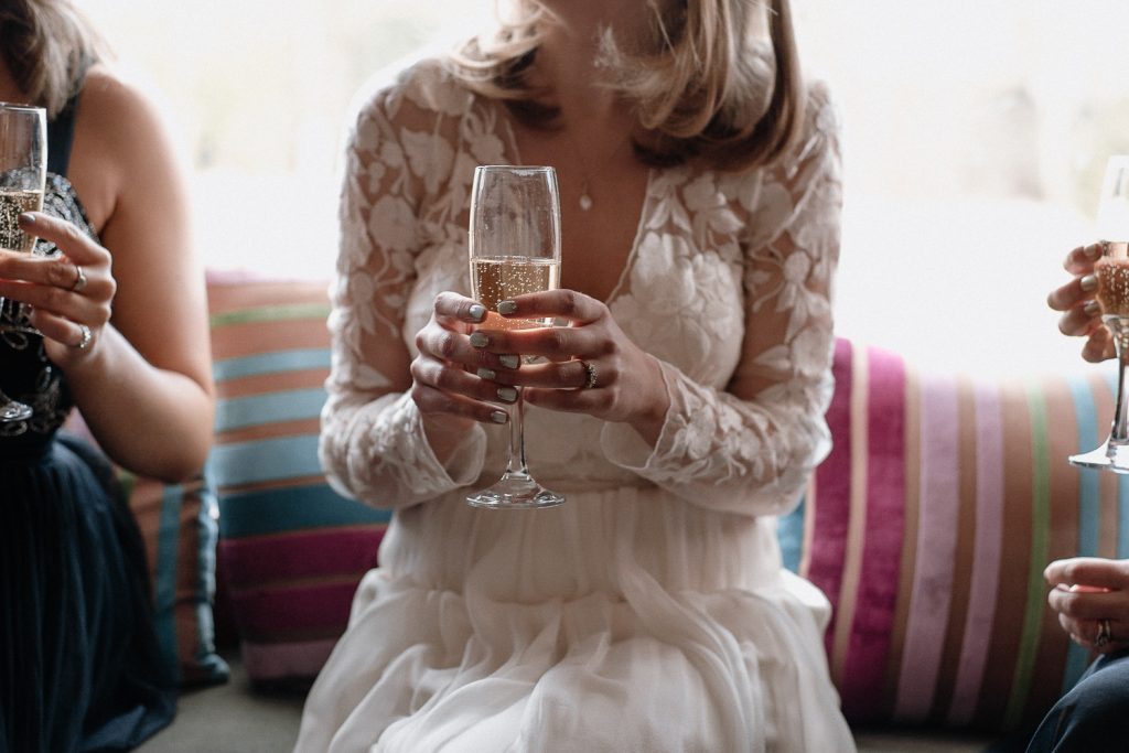 close up of bride holding champagne 