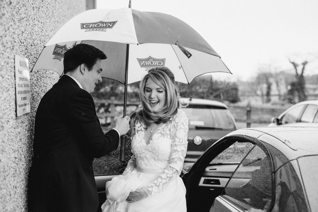 bride getting out of car, very windy 