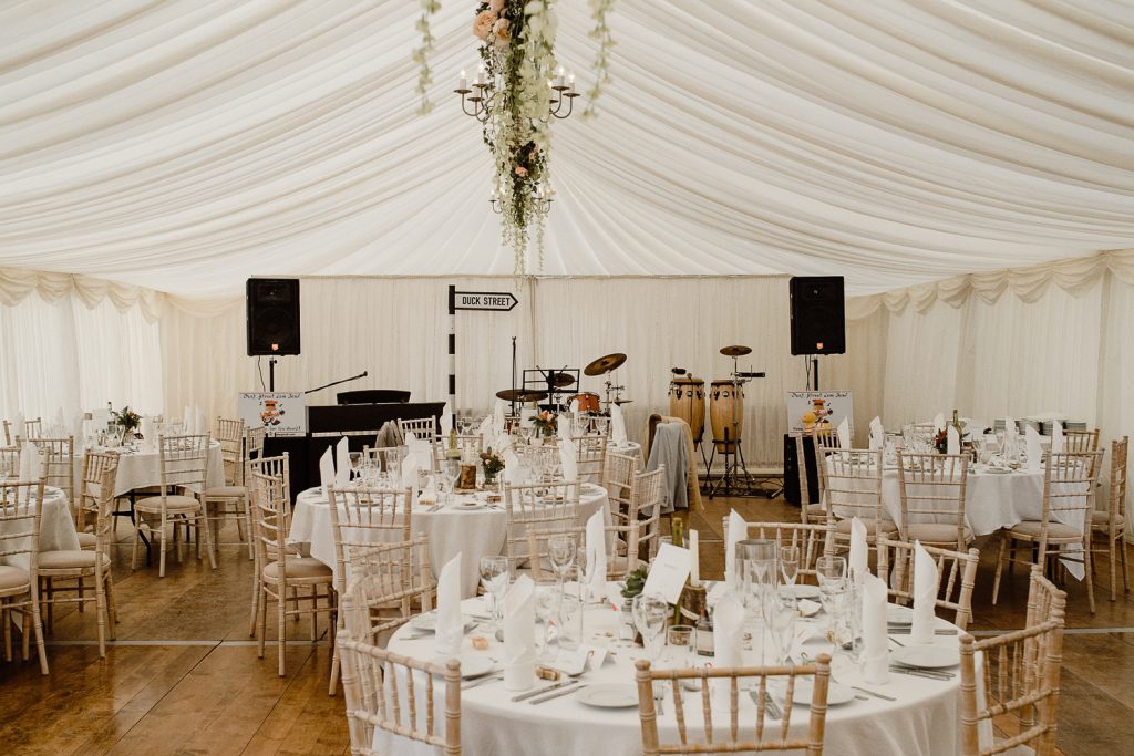 marquee decorated with tables and chairs for wedding 