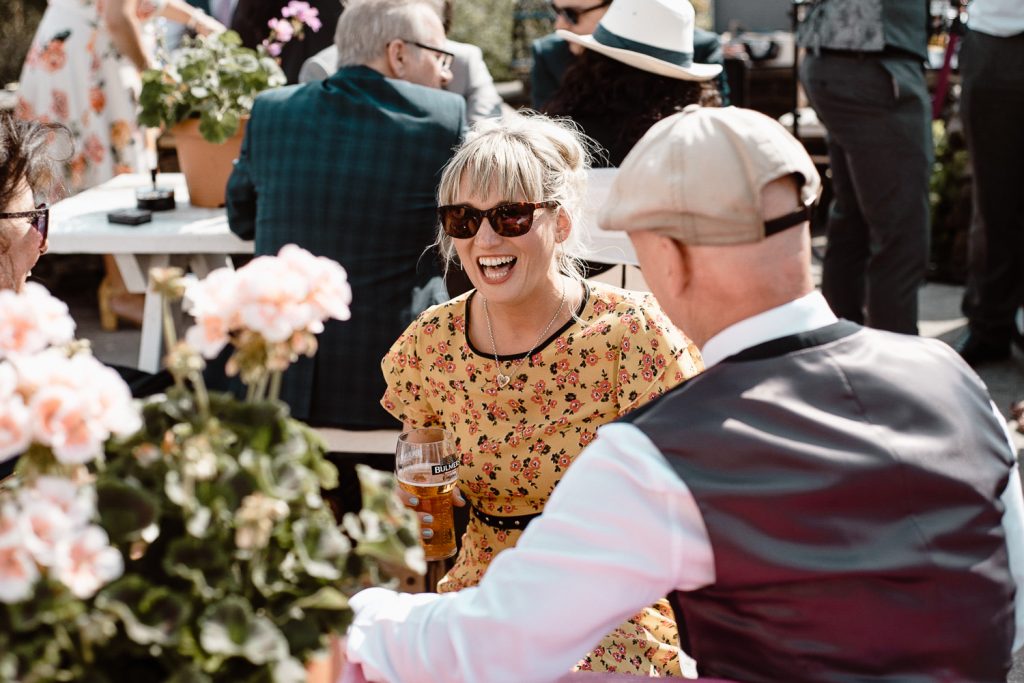 woman at wedding in glasses laughing 