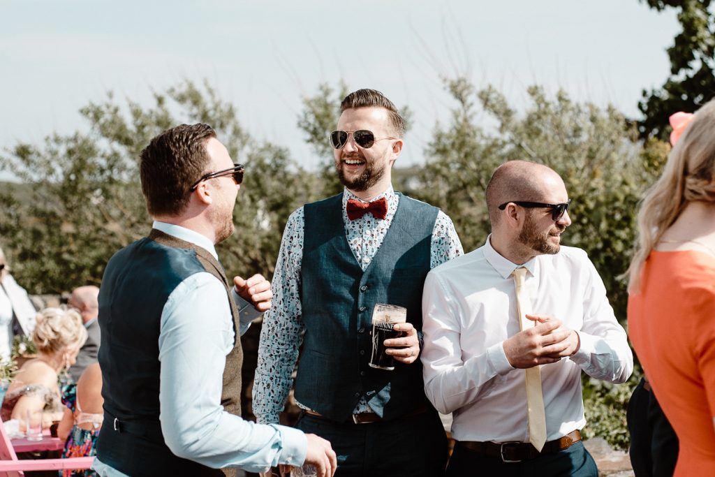 man in bowtie holding beer 