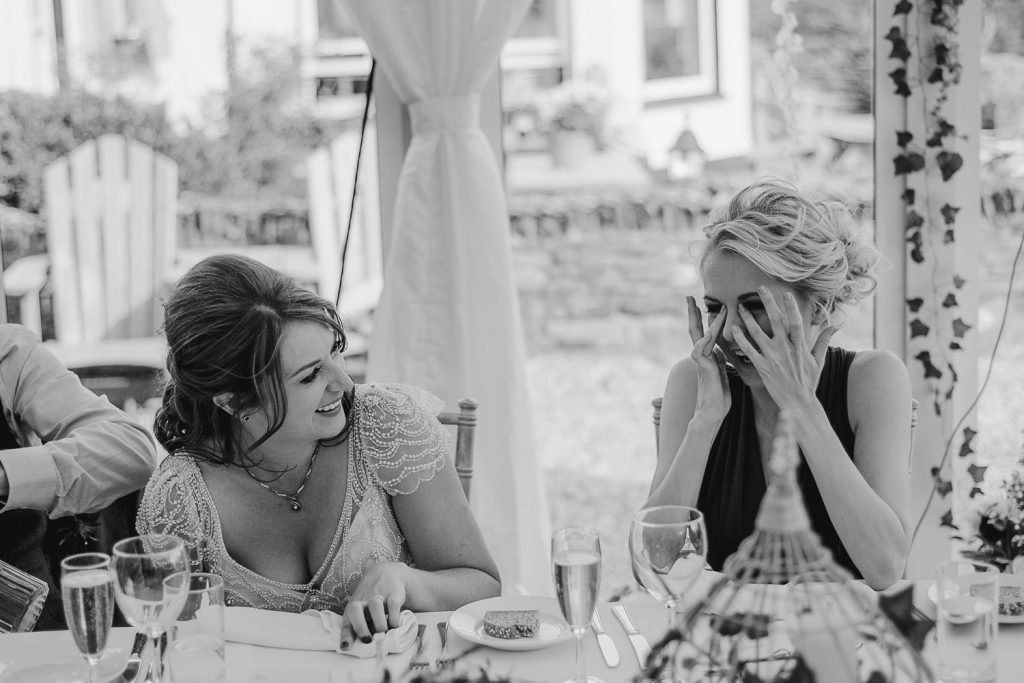 bride and bridesmaid laughing a lot 