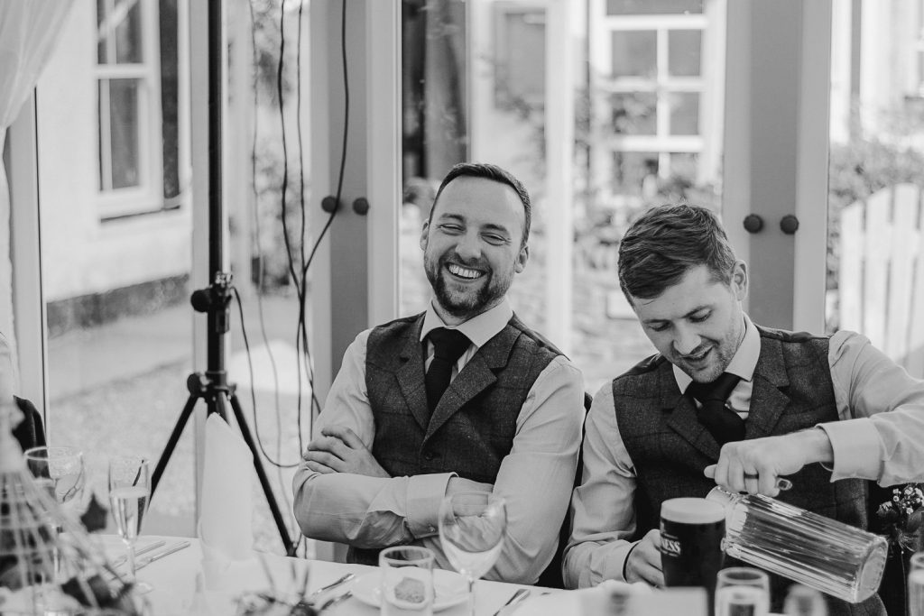 man in sie and waistcoat laughing 