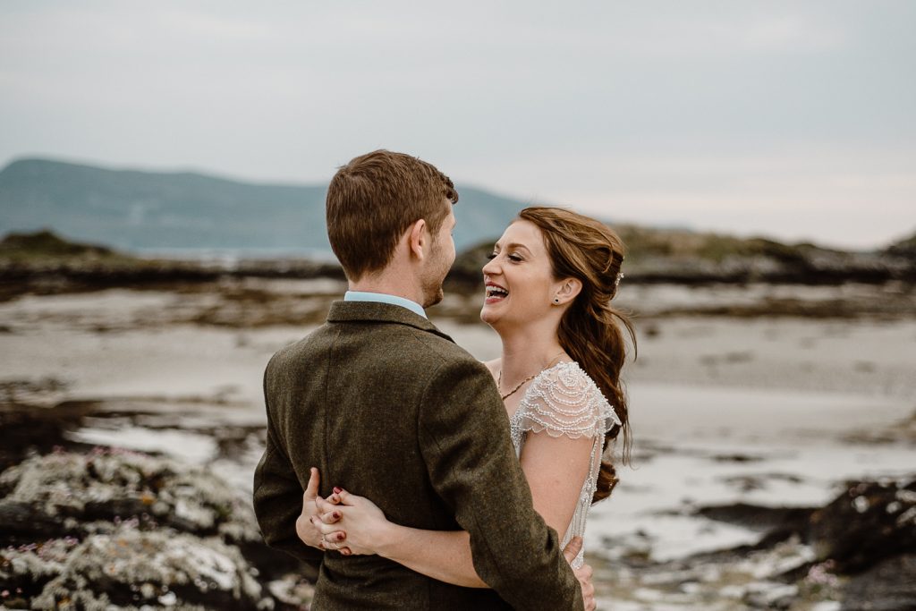 bride laughing and hugging groom
