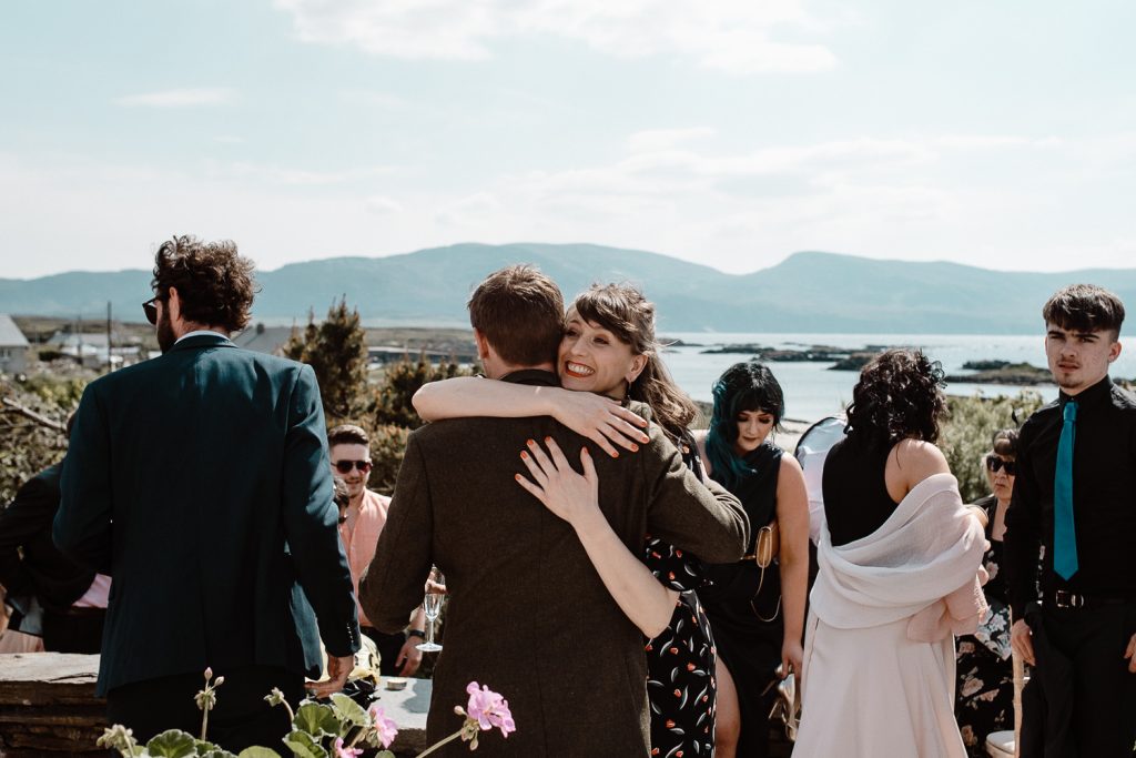 groom hugging guests 