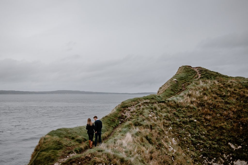 couple walking hand in hand up Kinbane head 