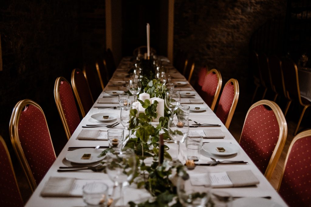 reception dinner table decorated with greenery