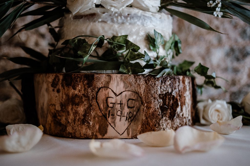 bride and grooms initials carved on tree trunk