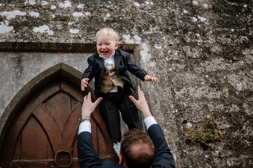 groom throwing his son in the air