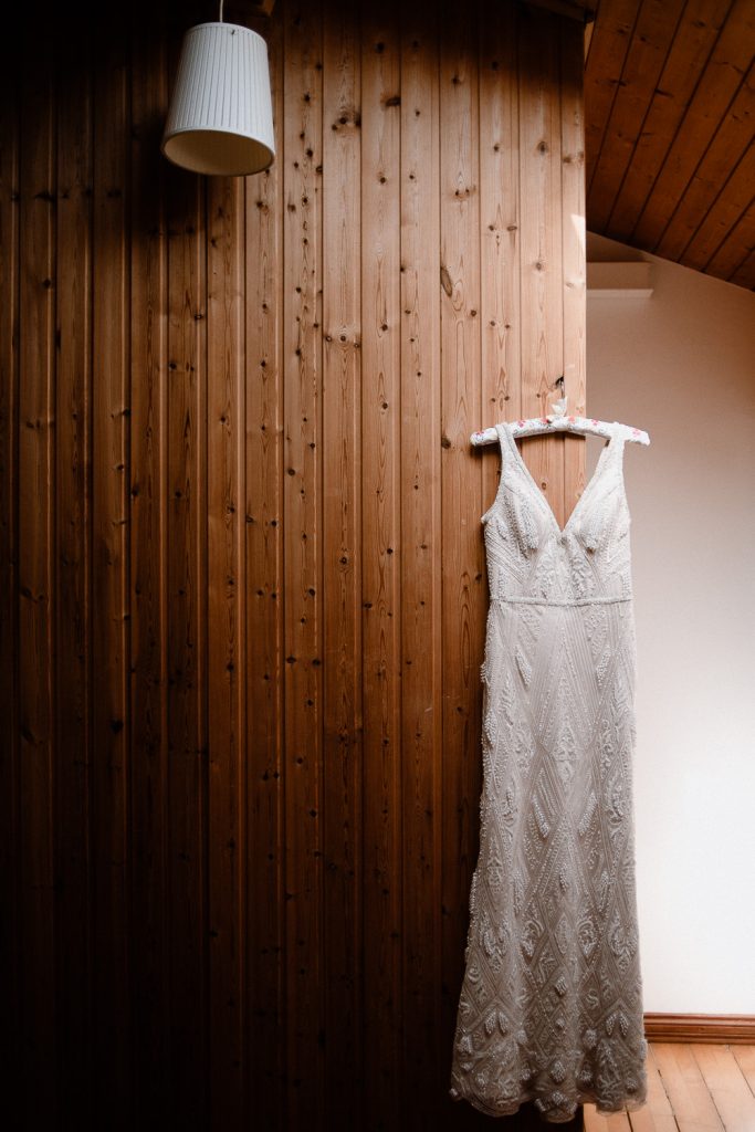Wedding dress on panelled wall