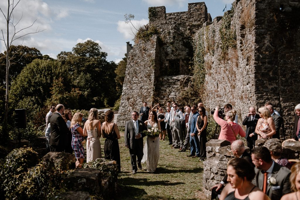Father and bride walk up the isle