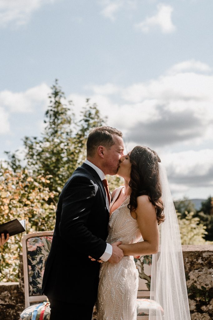 bride and grooms first kiss as a married couple