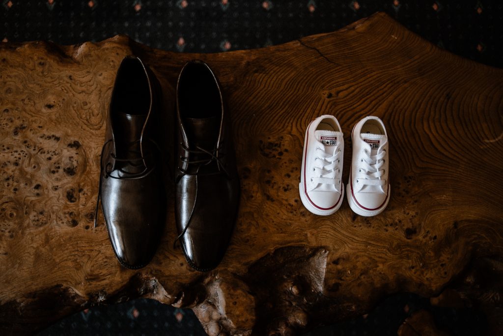 grooms shoes and small babies shoes side by side